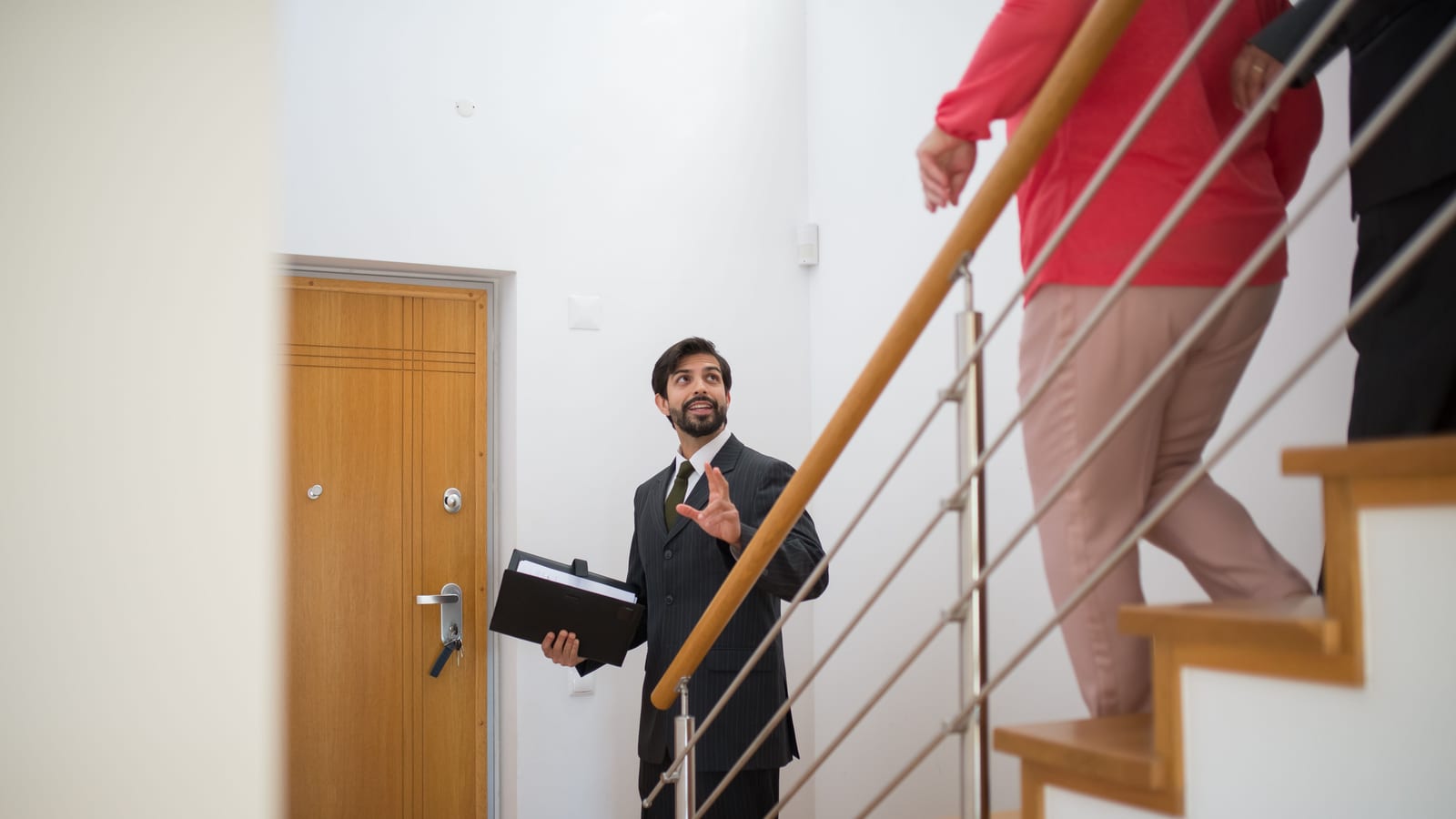 An estate agent showing a couple through a home